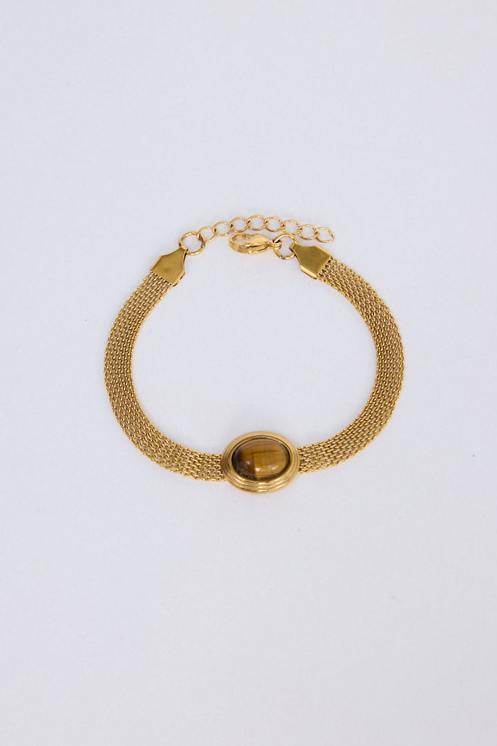 Model wearing Dorris Bracelet in amber with a central oval stone detail, stacked styling view on neutral background
