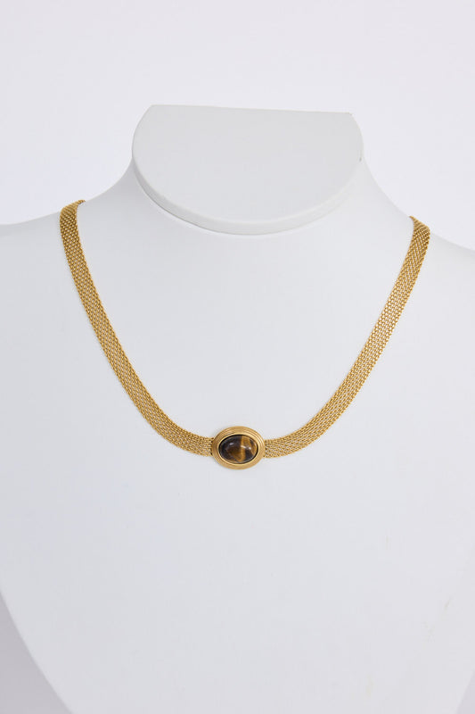 Dorris Necklace in amber with a central oval stone detail, side view on white background