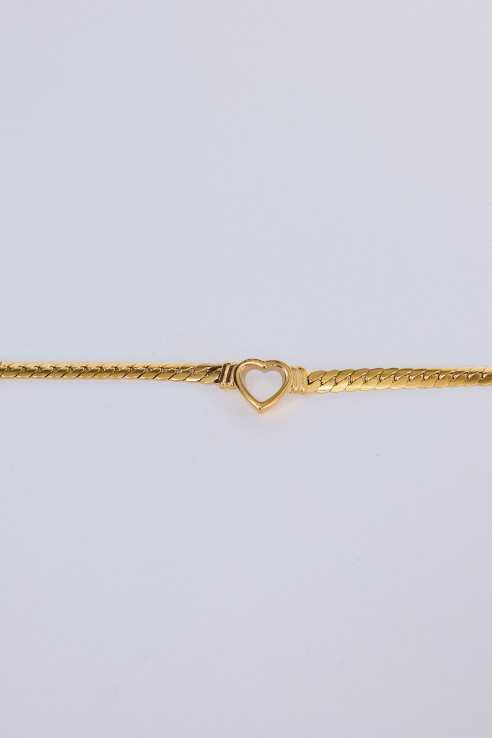 Hearts Bracelet in gold with delicate heart link detailing, flat lay detail view on white background