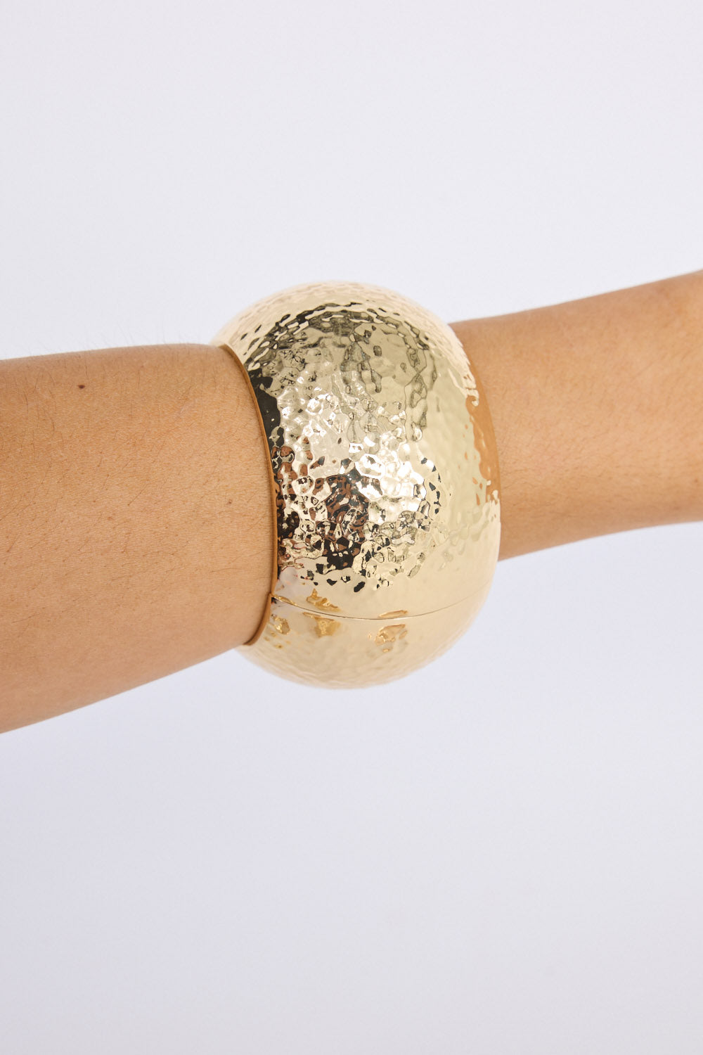 Model wearing Maura Bangle in gold with snap lock closure and hinge for easy wear, second stacked view on neutral background