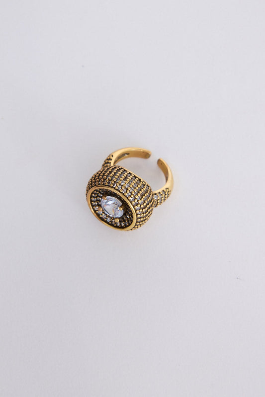 Halo Ring in gold with central stone and textured band detailing, angled view on white background