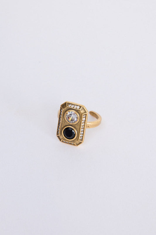 Zephyr Ring in gold with geometric face and stone detailing, front view on white background