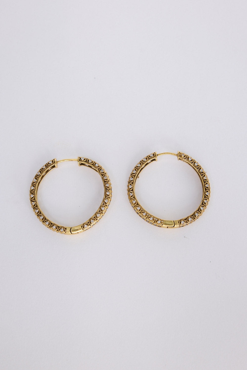 Colette Earrings in gold with subtle textured detailing, angled view on white background