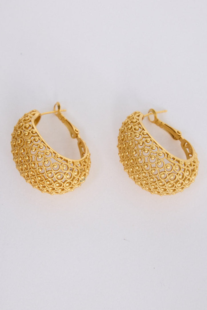 Meadow Earrings in gold with woven texture detailing, angled view on white background
