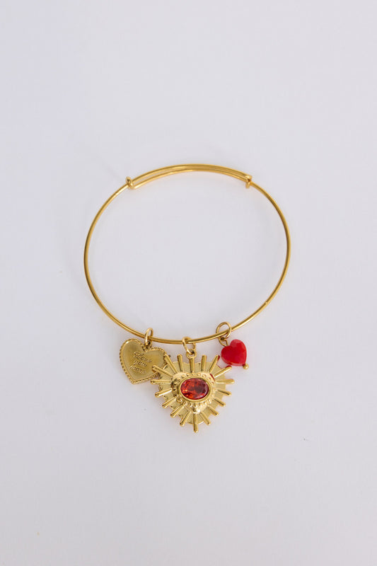 Royal Heart Bracelet in gold with multiple charm detailing, front view on white background