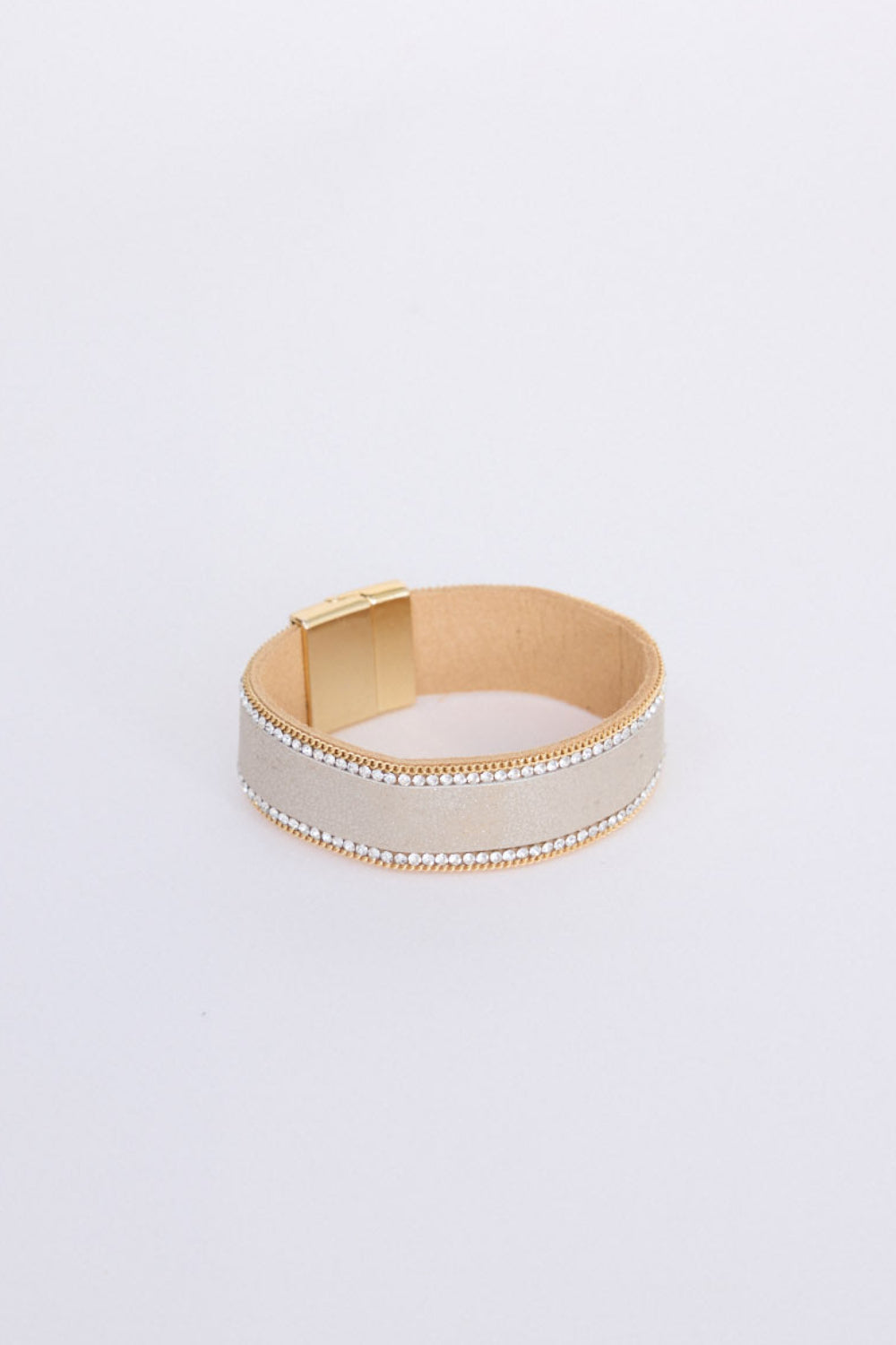Hilda Bracelet in gold with delicate crystal detailing, angled view on white background