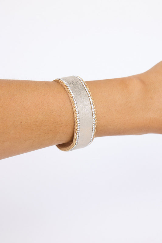 Model wearing Hilda Bracelet in gold with delicate crystal detailing, on-wrist view on neutral background