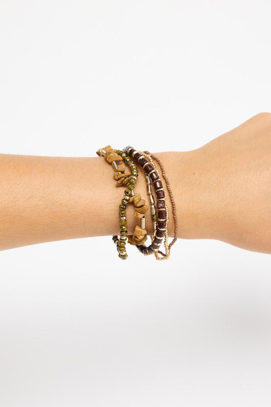 Solidarity Stack Bracelet in Natural worn stacked on the wrist, showing the multiple beaded strands layered together