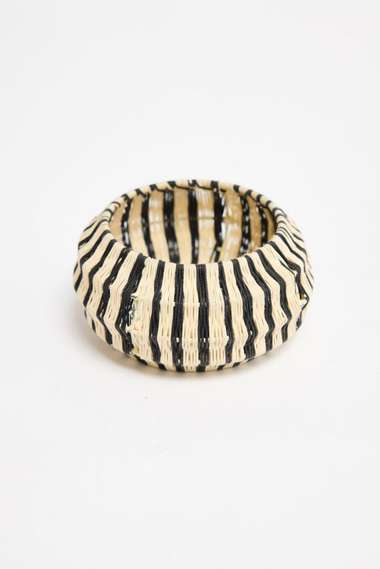 Top-down view of the Lancer Bangle in Stripe showing the woven cotton thread stripe pattern and rounded silhouette