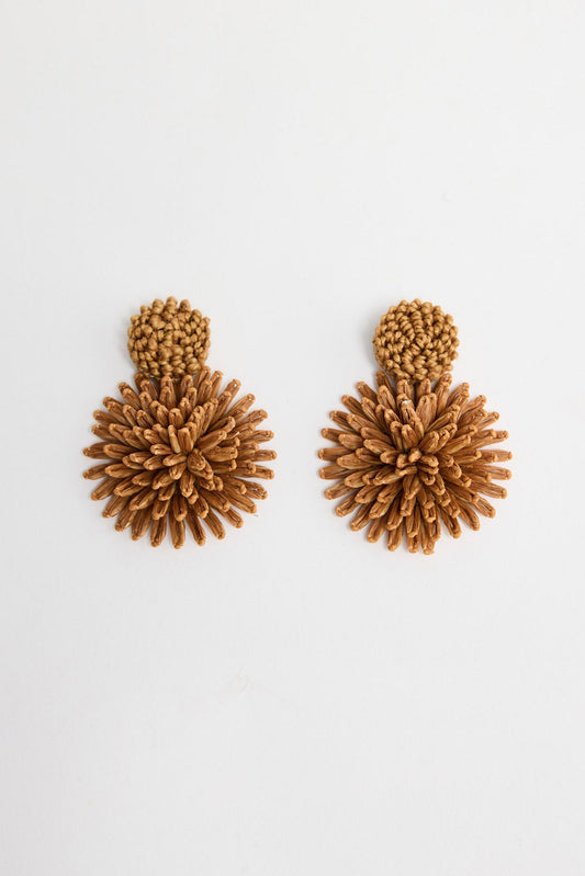 Pair of Polly statement earrings in Tan showing the woven raffia burst design and round textured stud on a white background