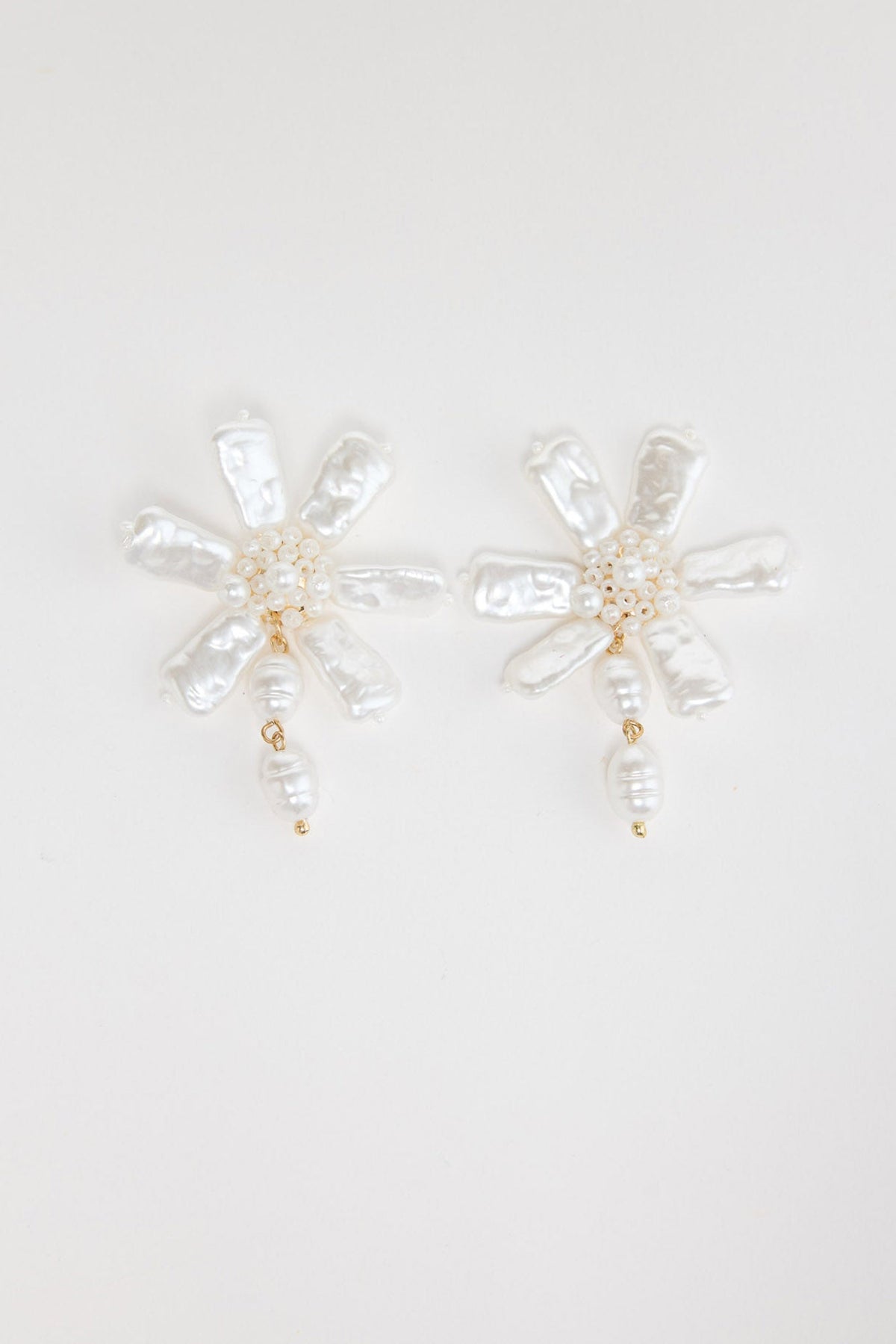 Pair of Zara floral earrings in Pearl showing freshwater pearl petals, beaded centre and pearl drop on a white background