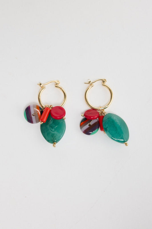 Pair of Elias drop earrings laid flat, showing gold-tone hoops with a green resin bead, red accents and a striped multicolour charm