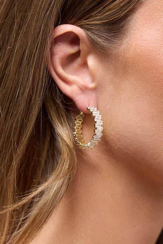 Oasis Earrings in Gold worn on the ear, showing the crystal-lined gold hoop close up against the lobe.