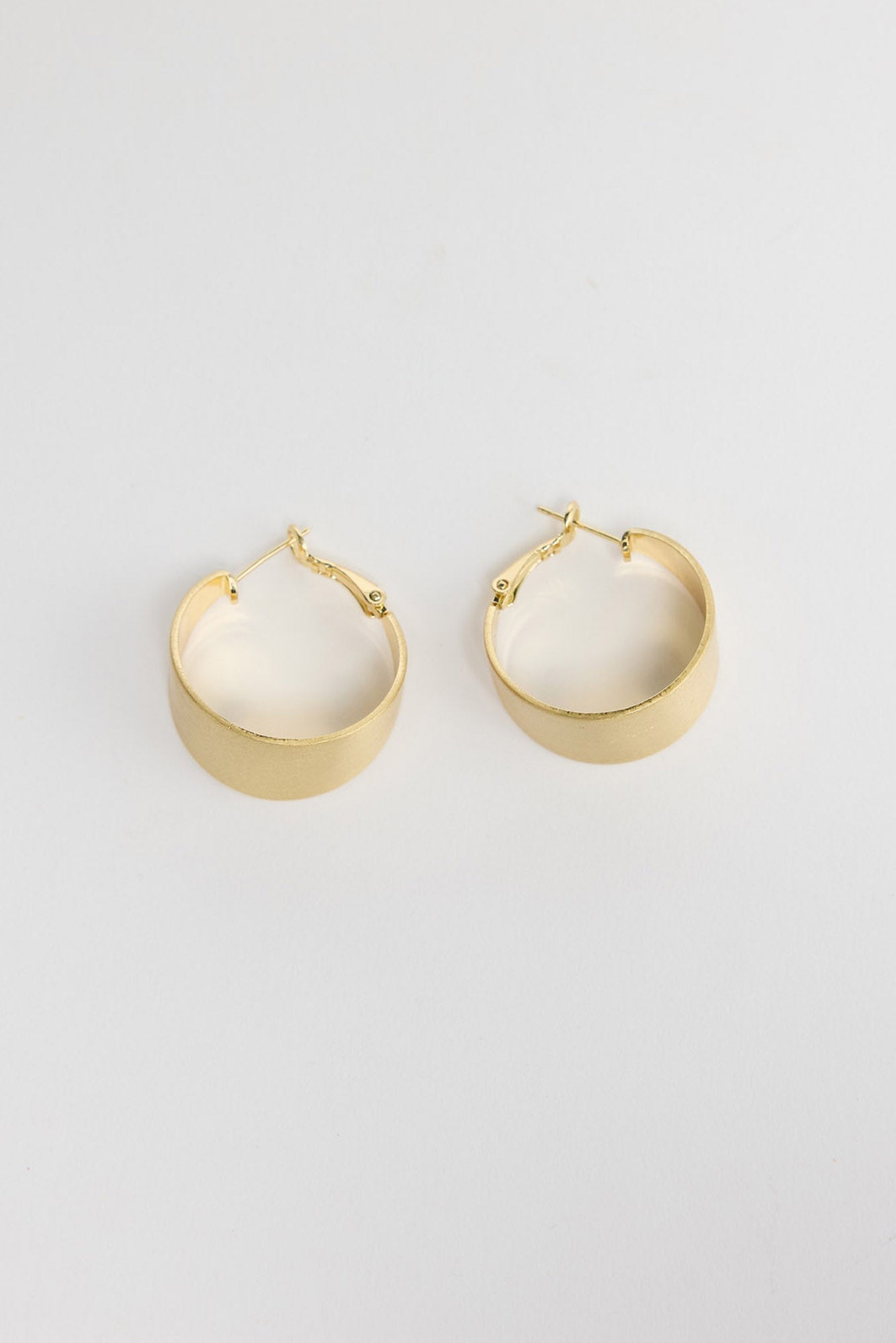 Siren Earrings in Gold, alternate angle showing the width and satin finish of the gold hoop.