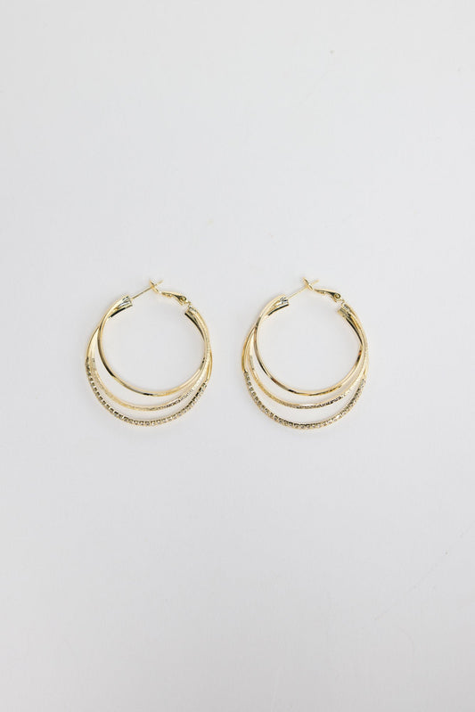 Seaspray Earrings in Gold – triple-layer gold-tone hoop earrings with one crystal-set row, shown flat on a white background.