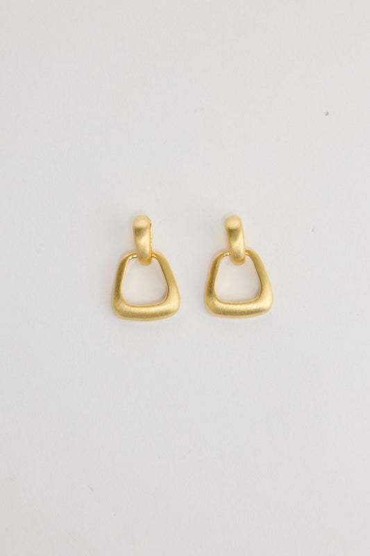 Swell Earrings in Gold – matte gold-tone geometric ring drop earrings shown flat on a white background.