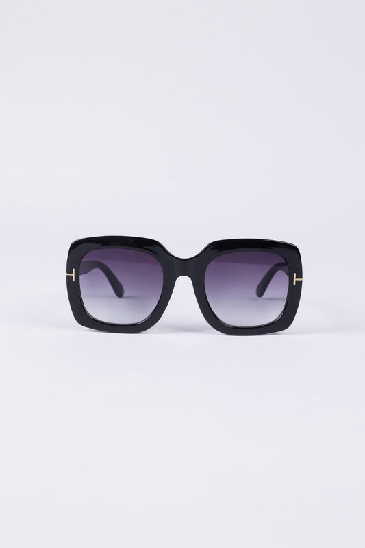 Black sunglasses with a gradient lens on a light purple background